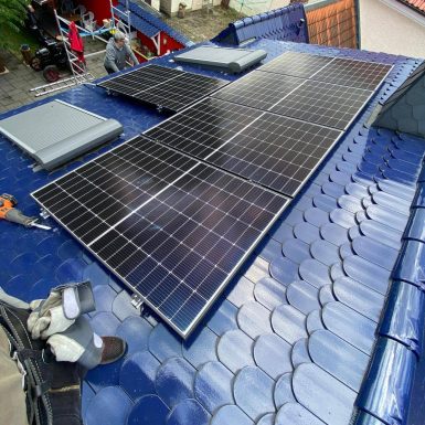 Solaranlage auf blauen Dachziegeln.